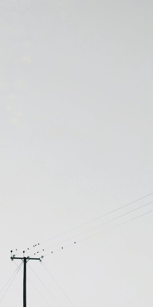 transmission post under white clouds