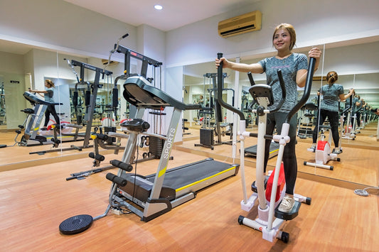 woman in gray long sleeve shirt standing on exercise equipment