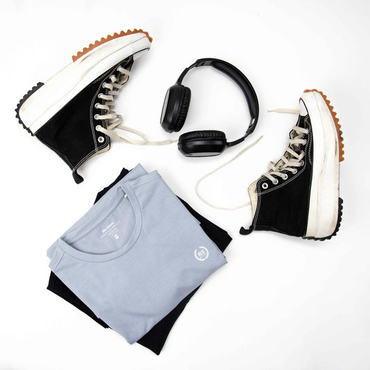 a pair of sneakers, headphones, and a t - shirt are laid out