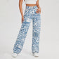 High-Waist Denim Pants with Blue Swirl Print – Stylish Wavy Ripple Graphic, Zipper Button Closure, and Slash Pockets - Ladies