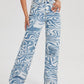 High-Waist Denim Pants with Blue Swirl Print – Stylish Wavy Ripple Graphic, Zipper Button Closure, and Slash Pockets - Ladies